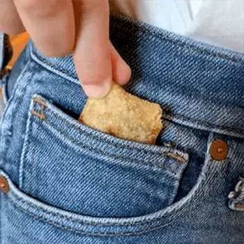 A girl's hand pulling Totino's Pizza Rolls from the pocket of her blue jeans. - Link to social post
